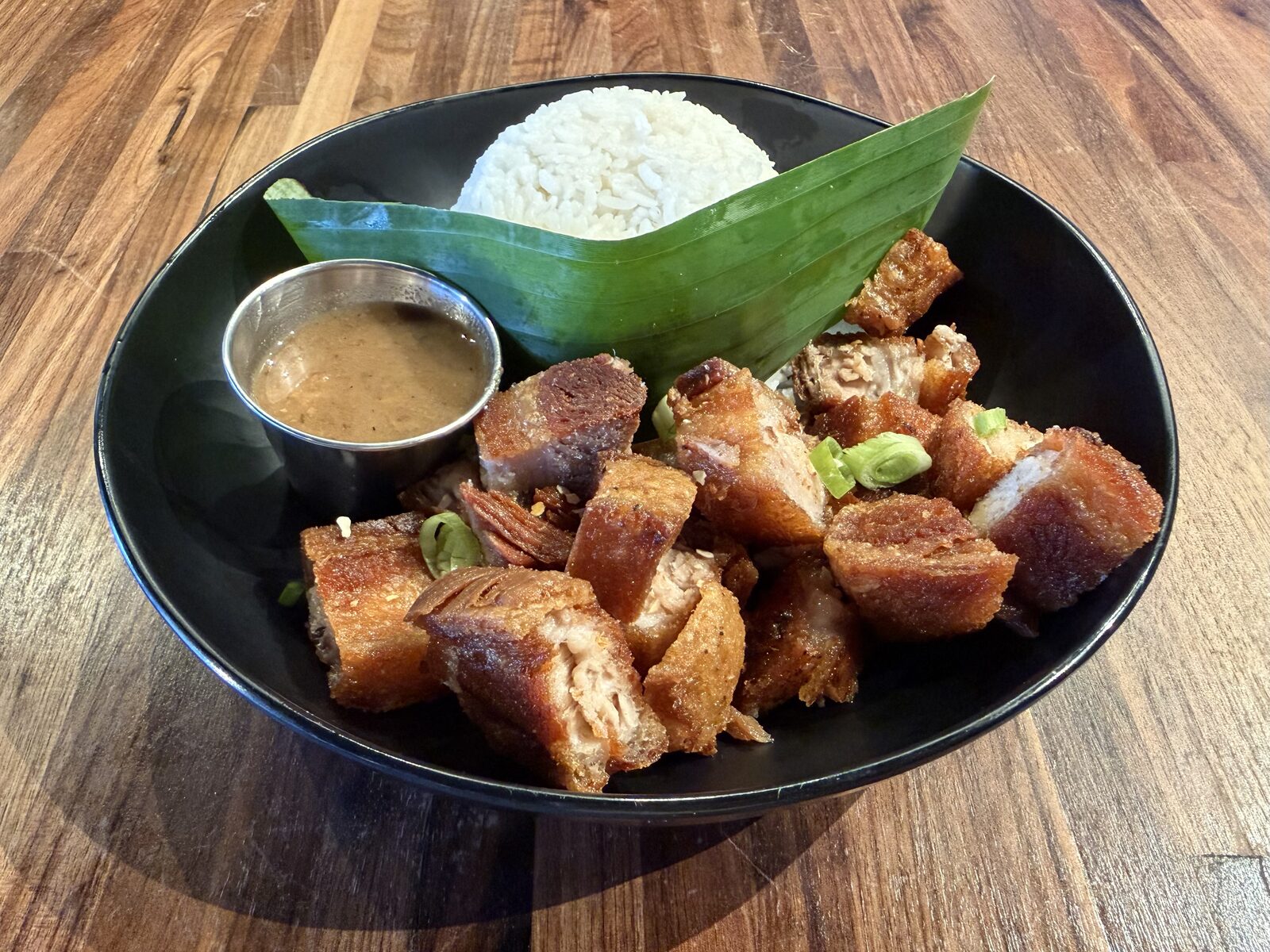 Crispy Lechon Kawali from Only at Renee's, served with rice and a side of sauce